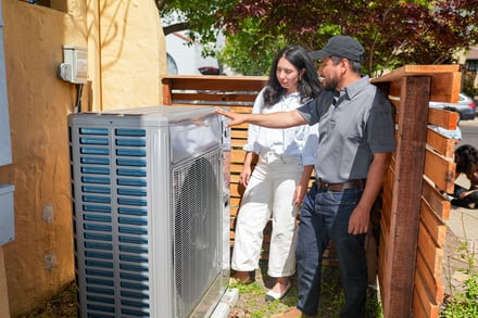 Contractor shows homeowner heat pump 